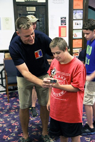 Maj. Brian Piekielko, the human resources officer in charge, Headquarters, Headquarters Company, 3rd Brigade Combat Team "Rakkasans," 101st Airborne Division (Air Assault), awards a young athlete with the Buddy Ball program a trophy at the Pinnacle bowling alley, Clarksville, Tenn., Aug. 27, 2013. (Army Photo by Spc. Brian Smith-Dutton, 3BCT Public Affairs)