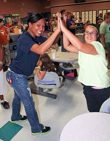 Sgt. 1st Class Takethia Branch, the retention non commissioned officer assigned to Headquarters, Headquarters Company, 3rd Brigade Combat Team "Rakkasans," 101st Airborne Division (Air Assault), celebrates with an athlete with the Buddy Ball program at the Pinnacle bowling alley, Clarksville, Tenn., Aug. 27, 2013. (Army Photo by Spc. Brian Smith-Dutton, 3BCT Public Affairs)