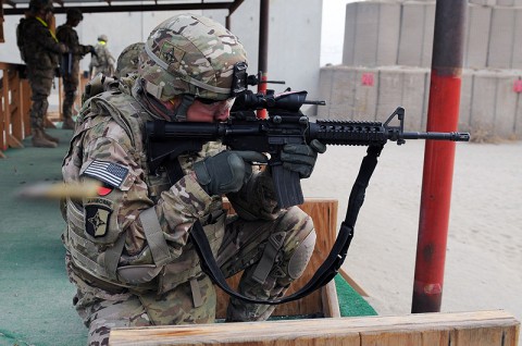 Sgt. 1st Class Kevin L. Mays, a native of Louisville, Ky., and support operations platoon sergeant with Task Force Lifeliner, fires his M4 carbine rifle during M4 qualification range, Sept. 13, 2013 at Bagram Air Field, Parwan province, Afghanistan.  (U.S. Army photo by Sgt. Sinthia Rosario, Task Force Lifeliner Public Affairs)