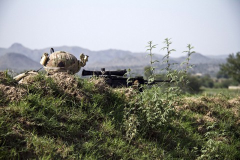 U.S. Army Sgt. Jesse L. Atkins, an infantryman with Easy Company, 2nd Battlion, 506th Infantry Regiment, 4th Brigade Combat Team, 101st Airborne Division (Air Assault), lies in the prone with his Mk-14 Enhanced Battle Rifle, scanning for potential threats, during a mission in the District of Saberi, Afghanistan, on August 21. (Sgt. Jusitn A. Moeller/U.S. Army)