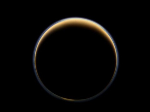 NASA's Cassini spacecraft looks toward the night side of Saturn's largest moon and sees sunlight scattering through the periphery of Titan's atmosphere and forming a ring of color. (NASA/JPL-Caltech/Space Science Institute)