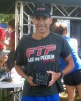 Russ Shemberger of RPM Massage in Clarksville accepts his first-place age group award in the half-iron distance at the annual Riverbluff Triathlon held Saturday, September 7th in Ashland City, TN.