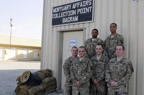 The Mortuary Affairs Collection Point Bagram team stand together for a group photo, Oct. 17, 2013 at Bagram Air Field, Parwan province, Afghanistan. Sgt. Jarrett D. Ransom (top left), a native of Memphis, TN, Pfc. Shawn Thomas (top right), a native of Raeford, NC, Staff Sgt. Joel Wood (bottom left), a native of Plattsburgh, NY, Spc. Cody J. Montalbano (center left), a native of Rochester, NY, Spc. Jeremy Bennett (center right), a native of Cromwell, Ky., and Pfc. Paul Shrum (bottom right) a native of Casa Grande, AZ, are all soldiers with the 54th Quartermaster Company out of Fort Lee, VA. (U.S. Army photo by Sgt. Sinthia Rosario)