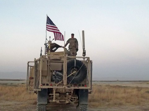 Sgt. Jeffery A. Carter, Sr., a native of Vienna, GA, stands on top of his vehicle at Forward Operating Base Kunduz in October 2013. Soldiers from the 1230th Transportation Company, a National Guard Unit out of Thomasville, GA, supported the 524th Combat Sustainment Support Battalion, made one last retrograde run to Kunduz to pick up the last items to be retrograded prior to transferring the base to Afghanistan’s security forces. (524th Combat Sustainment Support Battalion)