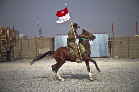 U.S. Army 1st Lt. Jeremy A. Woodard, an engineer officer with 1st Squadron, 61st Cavalry Regiment, 4th Brigade Combat Team, 101st Airborne Division (Air Assault), rides a horse while holding the Headquarters Troop Guidon, during a spur ceremony at Camp Clark, Afghanistan, Oct. 11, 2013. (U.S. Army photo by Sgt. Justin A. Moeller, 4th Brigade Combat Team Public Affairs)
