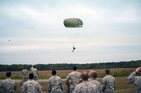 The last jumper from F Company, 5th Battalion, 101st Combat Aviation Brigade, 101st Airborne Division (Air Assault,) Pathfinders, parachutes into the drop zone to the cheers of his fellow companymates during the last jump of the Pathfinder company at Fort Campbell, Ky., Oct. 16, 2013. The jump was the last airborne operation in the history of the 101st Airborne Division. (U.S. Army photo by Sgt. Duncan Brennan, 101st CAB Public Affairs)