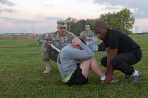 Sgt. Frans Vandiepenhuisen, C Company, 5th Battalion, 101st Combat Aviation Brigade, 101st Airborne Division (Air Assault,) UH-60 Black Hawk crew chief performs the situps while Sgt. 1st Class Jimmie Jones, F Company, 2nd Squadron, 17th Cavalry Regiment, platoon sergeant holds his feet and Sgt. 1st Class Paul Goeman, Headquarters and Headquarters Company, 101st CAB, operations noncommissioned officer grades the event ensuring all repetitions were conducted properly during an Army physical fitness test held at 101st CAB headquarters, Fort Campbell, Ky, Oct. 9, 2013. (U.S. Army photo by Sgt. Duncan Brennan, 101st CAB Public Affairs)