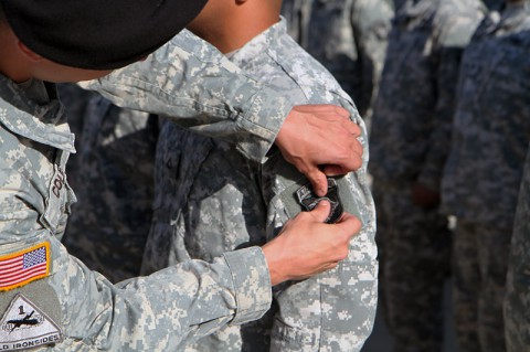 A soldier with the 326th Engineer Battalion is “patched” as his unit holds a patch changing ceremony to mark their unit’s return to the 1st Brigade Combat Team, 101st Airborne Division Oct. 18 at their battalion headquarters here. (Sgt. 1st Class John Brown)