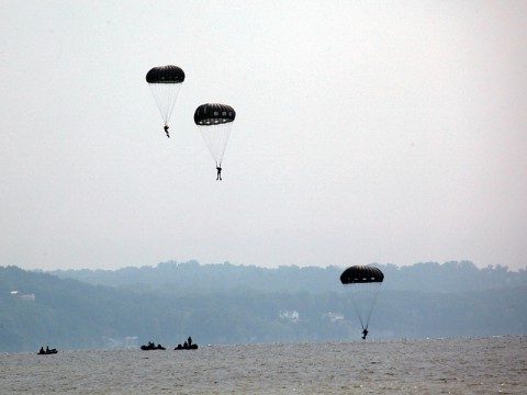 Green Berets from the 5th Special Forces Group (Airborne) parachute into a water drop zone marking the beginning of a two-day long competition testing their abilities as an Operational Detachment Alpha. (Photo by Spc. Seth Plagenza)