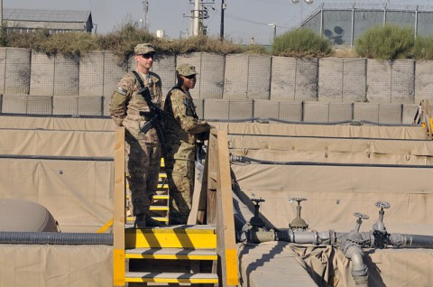 Spc. Dewayne M. Johnson, a native of Muncie, IN, and fuel manager with the outgoing unit the 1438th Transportation Company, 77th Combat Sustainment Support Battalion, Task Force Lifeliner, shows the fuel yard to his replacement Spc. Robert P. Ibarria, a native of Wheatfield, IN, with the 1638th Transportation Company as part of the relief in place, Nov. 11, 2013, at Camp Phoenix in Kabul, Afghanistan. (U.S. Army photo by Sgt. Sinthia Rosario, Task Force Lifeliner Public Affairs)