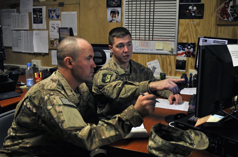 Sgt. Thomas D. Frazier (right), a native of Shelbyville, Ind., and support operations transportation National Afghan Trucking noncommissioned officer in charge for the outgoing unit the 1438th Transportation Company, 77th Combat Sustainment Support Battalion, Task Force Lifeliner, explains to his replacement Sgt. Theodore K. Roseberry (left), a native of Portage, Ind., with the incoming unit the 1638th Transportation Company, how to fill out a NAT tracker as part of the relief in place, Nov. 11, 2013, at Camp Phoenix in Kabul, Afghanistan.  (U.S. Army photo by Sgt. Sinthia Rosario, Task Force Lifeliner Public Affairs)