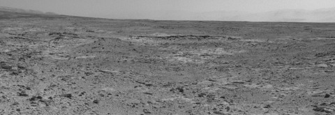 The low ridge that appears as a dark band below the horizon in the center of this scene is a Martian outcrop called "Cooperstown," a possible site for contact inspection with tools on the robotic arm of NASA's Mars rover Curiosity. The ridge extends roughly 100 feet (about 30 meters) from left to right, and it is about 260 feet (about 80 meters) away from the location from which Curiosity captured this view.