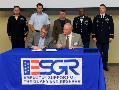 As Service Members look on, Nissan's senior vice president, administration and finance, Scott Becker (L) and ESGR National Chair, Paul Mock sign the Statement of Support on Wednesday, Nov. 13th, 2013 at Nissan America Headquarters in Franklin, TN.