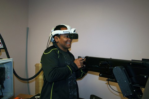 Ultimate Fighting Championship guest fighter Fredson Paixao gets the hang of the virtual gunner responsibility during a simulated convey. This simulation is used as a team approach to help Soldiers regain their Soldiering skills when recovering from a traumatic brain injury. Paixao, along with fellow UFC guest fighters Chuck Liddell, Forrest Griffin and Jim Miller, received a hands-on tour Nov. 4, 2013 of portions of TBI therapy sessions that Soldiers receive at Fort Campbell's Warrior Resiliency and Recovery Center, soon to be a National Intrepid Center of Excellence satellite site, known as the Intrepid Spirit. (U.S. Army Photo by Laura Boyd)