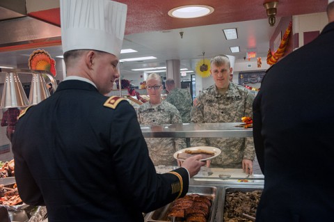 Soldiers from 101st Combat Aviation Brigade, 101st Airborne Division (Air Assault,) get served lunch by brigade staff officers and noncommissioned officers during the 101st CAB Thanksgiving meal at the Son Cafe dining facility on Fort Campbell, Ky., Nov. 26, 2013. The tradition of senior leadership serving holiday meals to soldiers is a long-running tradition that is meant to foster esprit de corps. (U.S. Army photo by Sgt. Duncan Brennan, 101st CAB Public Affairs)