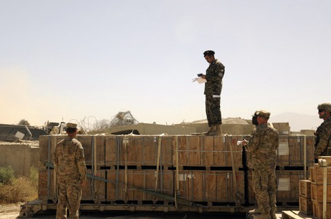 Afghan Maj. Raheem Shama, commander of the Afghan National Army Ammunition Depot (22 Bunkers), stands on top of palletized bundles small arms ammunition as he inventories each pallet at Bagram Air Field, Parwan province, Afghanistan on Aug. 26, 2013. (U.S. Army photo by Sgt. Sinthia Rosario)