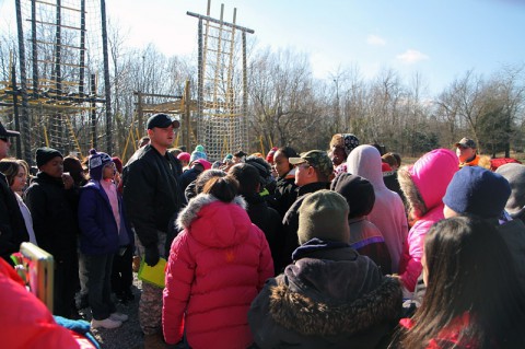 U.S. Army Staff Sgt. Zilvinas Lapelis, a senior instructor at The Sabalauski Air Assault School, shows students from West Creek Elementary School in Clarksville, Tenn., the Air Assault obstacle course, while on a field trip on Dec. 10, 2013, at Fort Campbell. (U.S. Army photo by Sgt. Justin A. Moeller, 4th Brigade Combat Team Public Affairs)