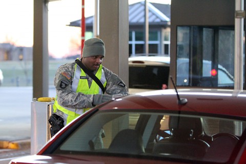 Sgt. Andre Garrett, a light wheel mechanic from Troop E, 2nd Squadron, 17th Cavalry Regiment, 101st Combat Aviation Brigade, 101st Airborne Division (Air Assault), checks identifications Dec. 12, at Fort Campbell's main gate. Garrett is one of 72 soldiers from the division who recently assumed the bulk of Fort Campbell's access control point mission. (U.S. Army photo by Sgt. Leejay Lockhart, 101st Sustainment Brigade Public Affairs)