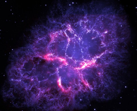 This image shows a composite view of the Crab nebula, an iconic supernova remnant in our Milky Way galaxy, as viewed by the Herschel Space Observatory and the Hubble Space Telescope. (ESA/Herschel/PACS/MESS Key Programme Supernova Remnant Team; NASA, ESA and Allison Loll/Jeff Hester (Arizona State University))