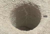 The hole that NASA’s Curiosity Mars rover drilled into target rock “John Klein” provided a view into the interior of the rock, as well as obtaining a sample of powdered material from the rock. (NASA/JPL-Caltech/MSSS)