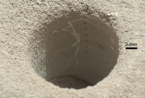 The hole that NASA's Curiosity Mars rover drilled into target rock "John Klein" provided a view into the interior of the rock, as well as obtaining a sample of powdered material from the rock. (NASA/JPL-Caltech/MSSS) The hole that NASA's Curiosity Mars rover drilled into target rock "John Klein" provided a view into the interior of the rock, as well as obtaining a sample of powdered material from the rock. (NASA/JPL-Caltech/MSSS)