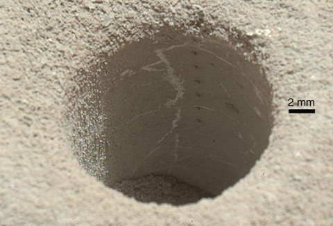 The hole that NASA's Curiosity Mars rover drilled into target rock "John Klein" provided a view into the interior of the rock, as well as obtaining a sample of powdered material from the rock. (NASA/JPL-Caltech/MSSS)