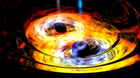 Two black holes are entwined in a gravitational tango in this artist's conception. Supermassive black holes at the hearts of galaxies are thought to form through the merging of smaller, yet still massive black holes, such as the ones depicted here. (NASA)