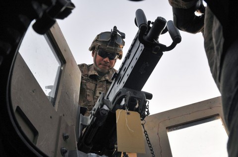 Spc. Sione Loketi, a native of Phoenix, AZ, and a gunner for 2nd Platoon (Lancers), 51st Transportation Company, 77th Combat Sustainment Support Battalion, in support of Task Force Lifeliner, inspects the gunner’s weapons system as part of preparation for upcoming missions, Dec. 22, 2013 at Bagram Air Field, Parwan province, Afghanistan.  (U.S. Army photo by Sgt. Sinthia Rosario, Task Force Lifeliner Public Affairs)