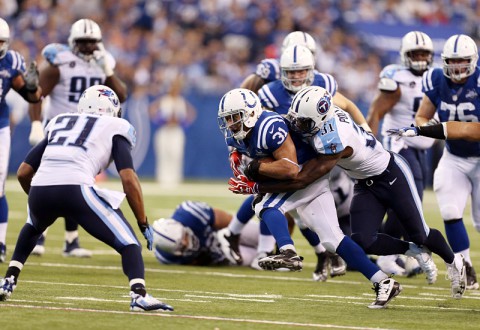 Indianapolis Colts running back Donald Brown (31) is tackled by Tennessee Titans safety Bernard Pollard (31) at Lucas Oil Stadium. Indianapolis defeats Tennessee 22-14. (Brian Spurlock-USA TODAY Sports)