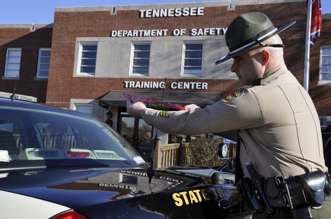 Tennessee State Trooper ties Mothers Against Drunk Driving ribbon on his patrol car.