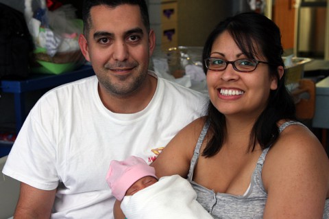 Maya Vasquez rests in her parents' embrace at Blanchfield Army Community Hospital on Fort Campbell, KY. (U.S. Army photo by Stacy Rzepka/RELEASED)