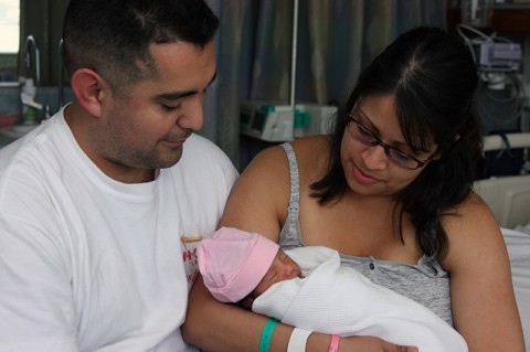 Maya Vasquez rests in her parents' embrace at Blanchfield Army Community Hospital on Fort Campbell, KY. (U.S. Army photo by Stacy Rzepka/RELEASED)