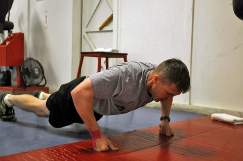 Maj. Erik A. Spicer, a native of Clarksville, Tenn., and the 101st Sustainment Brigade chaplain, assumes a push-up position during his daily burpee exercises as part of the 100-day burpee challenge, Jan. 9, 2014, at Bagram Air Field, Parwan province, Afghanistan. (U.S. Army photo by Sgt. Sinthia Rosario, Task Force Lifeliner Public Affairs)