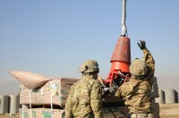 Spc. Hanook M. Chi, a native of Seoul (right), South Korea and Spc. Vonza Abney (left), a native of Hinesville, Ga., both parachute riggers with Task Force Lifeliner, hook up sustainment supplies to a cargo hook slung down from a contracting aircraft as it approaches for pick up during sling load operations, Jan. 6, 2014 at Bagram Air Field, Parwan province, Afghanistan. (Sgt. Sinthia Rosario, Task Force Lifeliner Public Affairs)