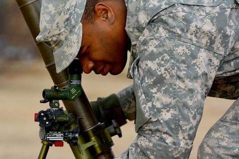 Pfc. Kelvin W. Otey, a mortarman with Company A, 1st Battalion, 327th Infantry Regiment, 1st Brigade Combat Team, 101st Airborne Division, looks down the sight of his 60 mm mortar tube during gunner preparedness training Jan. 15 at Johnson Field. (Sgt. 1st Class John Brown)