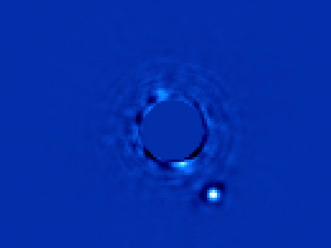 This image taken by the Gemini Planet Imager (GPI) shows a planet orbiting the star Beta Pictoris. In addition to the image, the GPI obtains spectral information from every pixel element in the field of view, allowing scientists to study the planet in great detail. (Gemini/Christian Marois, NRC Canada)