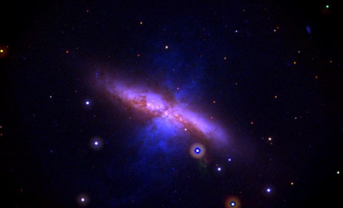 This Swift UVOT image shows M82 before the explosion and combines data acquired between 2007 and 2013. Mid-ultraviolet light is shown in blue, near-UV light in green, and visible light in red. The image is 17 arcminutes across, or slightly more than half the apparent diameter of a full moon. (NASA/Swift/P. Brown, TAMU)