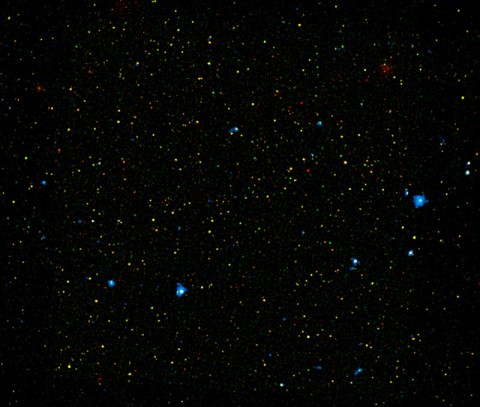 A range of supermassive black holes lights up this new image from NASA's Nuclear Spectroscopic Telescope Array, or NuSTAR. All of the dots are active black holes tucked inside the hearts of galaxies, with colors representing different energies of X-ray light. (NASA/JPL-Caltech/Yale University)