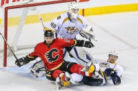 Calgary Flames left wing T.J. Galiardi (39) and Nashville Predators defenseman Ryan Ellis (4) collide in front of Predators goalie Devan Dubnyk (40) during the first period at Scotiabank Saddledome. (Sergei Belski-USA TODAY Sports)