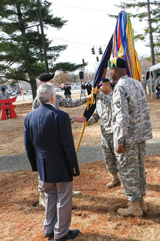 Col. J.B. Vowell, the commander of 3rd Brigade Combat Team “Rakkasans,” 101st Airborne Division (Air Assault), passes the unit colors to the incoming senior enlisted advisor Command Sgt. Maj. Walter Tagalicud during the Rakkasan Activation Ceremony here Feb. 19, 2014. (Photo by Sgt. Brian Smith-Dutton, 3rd BCT Public Affairs)