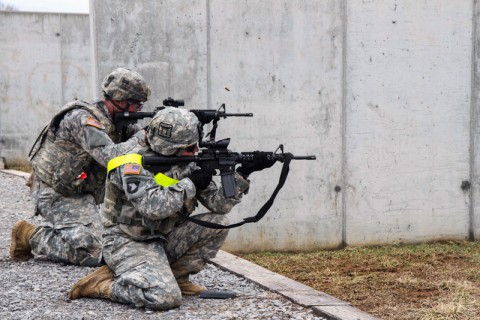 1st Lt. Alyssa Fellows (Right) and Pfc. Michael Gray (Left), both assigned to 1st Squadron, 33rd Cavalry Regiment, 3rd Brigade Combat Team “Rakkasans,” 101st Airborne Division (Air Assault), fire their their M4 Carbine Rifles at the range during the ‘Best Rakkasan’ competition, here, Feb. 20, 2014. The competition was held was the first of its kind and was designed to measure the overall proficiency of selected teams and award them with the title of ‘Best Rakkasan’ through competitive events. (Sgt. Brian Smith-Dutton/U.S. Army)