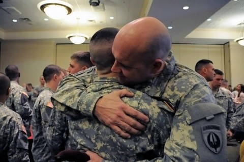 Staff Sgt. Joseph Simms and Pvt. Charlie Shaw share a hug following the Combat Skills Enlisted Green Platoon graduation ceremony, Feb. 18, 2014 at Fort Campbell, Ky. (Staff Sgt. Rick Branch/U.S. Army).