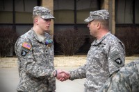 Spc. Brian D. Messersmith (left), a Soldier with Able Company, 1st Battalion, 506th Infantry Regiment, 4th Brigade Combat Team, 101st Airborne Division (Air Assault), shakes hand with Col. Val C. Keaveny Jr., commander of the 4th BCT, 101st Abn. Div., received two Army Commendation Medals, one with a Valor device, as well as a Purple Heart, during a ceremony Feb. 7, 2014. (U.S. Army photo by Sgt. Justin A. Moeller, 4th Brigade Combat Team Public Affairs)