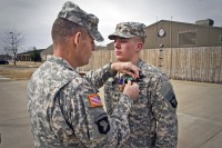 Spc. Brian D. Messersmith (right), a soldier with Able Company, 1st Battalion, 506th Infantry Regiment, 4th Brigade Combat Team, 101st Airborne Division (Air Assault), received two Army Commendation Medals, one with a Valor device, as well as a Purple Heart, from Lt. Col. Gregory Beaudoin, commander of 1st Bn., 506th Inf. Regt., 4th BCT, 101st Abn. Div., during a ceremony Feb. 7, 2014. (U.S. Army photo by Sgt. Justin A. Moeller, 4th Brigade Combat Team Public Affairs)