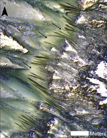 Dark, seasonal flows emanate from bedrock exposures at Palikir Crater on Mars in this image from the High Resolution Imaging Science Experiment (HiRISE) camera on NASA's Mars Reconnaissance Orbiter. (NASA/JPL-Caltech/Univ. of Arizona)