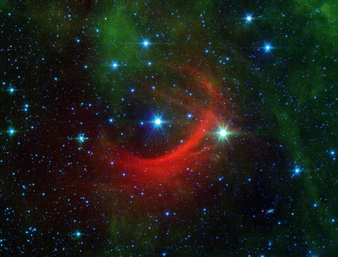 The red arc in this infrared image from NASA's Spitzer Space Telescope is a giant shock wave, created by a speeding star known as Kappa Cassiopeiae. (NASA/JPL-Caltech) The red arc in this infrared image from NASA's Spitzer Space Telescope is a giant shock wave, created by a speeding star known as Kappa Cassiopeiae. (NASA/JPL-Caltech)
