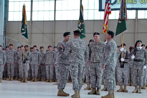 Colonel John Brennan, commander of the 5th Special Forces Group (Airborne) passes the traditional sword to Command Sgt. Maj. Lyle Marsh, signifying the passing of responsibility from the outgoing senior noncommissioned officer of The Legion to the incoming during an assumption of responsibility ceremony held at Fort Campbell, KY, March 7th, 2014 (Staff Sgt. Barbara Ospina)