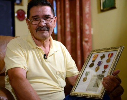 Former Spc. 4 Santiago Erevia reflects on his service medals and awards, which include a South Vietnamese medal, an Army Commendation Medal, a Purple Heart, a Bronze Star and the nation’s second highest award for valor, the Distinguished Service Cross. While Erevia was deployed to Vietnam in May 1969 as a radio-telephone operator with the 101st Airborne Division, he had been assigned to care for the wounded during a search-and-clear mission while the rest of his platoon penetrated an enemy defensive perimeter. After North Vietnamese soldiers attacked his position, Erevia rushed forward into heavy fire, single-handedly destroying four enemy bunkers with grenades and M-16 fire. After reviewing Erevia’s actions, President Barack Obama will award Erevia the Medal of Honor in a February 2014 ceremony. (Elizabeth M. Collins/DOD)