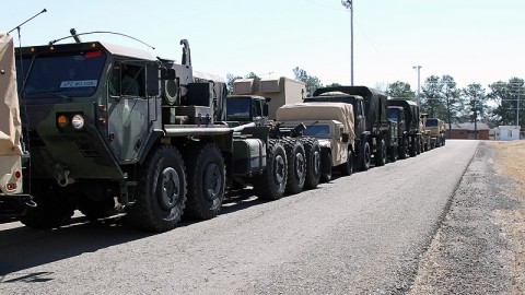 Soldiers from the 129th Combat Sustainment Support Battalion, 101st Sustainment Brigade, 101st Airborne Division (Air Assault), wait for personnel from the 632nd Movement Control Team to check their vehicles before their turn at the weigh station by the Alert Holding Area Feb. 26, at Fort Campbell, KY. Accurately determining the equipment’s weight and center of balance allows for safe transport by air. (Sgt. Leejay Lockhart, 101st Sustainment Brigade Public Affairs)