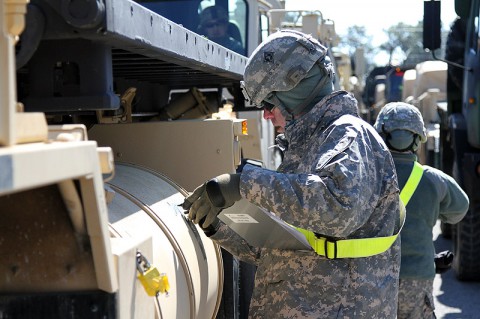 Sgt. Joseph G. Anthony, a transportation management coordinator with the 632nd Movement Control Team, 129th Combat Sustainment Support Battalion, 101st Sustainment Brigade, 101st Airborne Division (Air Assault), marks vehicles during a training exercise that validates the readiness of units to rapidly deploy Feb. 26, at Fort Campbell, Ky. The readiness exercise provides valuable feedback to determine how well-prepared a unit is for rapid movement. (Sgt. Leejay Lockhart, 101st Sustainment Brigade Public Affairs)